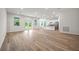 A bright, open-concept living room with hardwood floors, white walls, and access to the backyard at 27263 Deep Creek Blvd, Punta Gorda, FL 33983