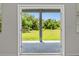 View of the yard from the patio through open glass doors at 27263 Deep Creek Blvd, Punta Gorda, FL 33983