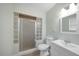 Bathroom featuring a glass block shower, toilet, vanity and sink at 31 Oberlin Rd, Venice, FL 34293