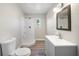 Bathroom with corner shower, window, white vanity and sink at 31 Oberlin Rd, Venice, FL 34293