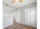 This bedroom offers wood floors, a ceiling fan, and easy access to another room through an open doorway at 31 Oberlin Rd, Venice, FL 34293