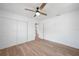 Bedroom features a ceiling fan, wood floors, and a double closet at 31 Oberlin Rd, Venice, FL 34293