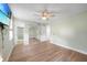 This bedroom features wood floors, a ceiling fan and a closet with mirrored doors at 31 Oberlin Rd, Venice, FL 34293