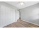 This bedroom has wood floors, a ceiling fan and a closet with double doors at 31 Oberlin Rd, Venice, FL 34293