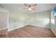 Light and airy bedroom with wood floors, a ceiling fan, TV and a neutral color scheme for a calming retreat at 31 Oberlin Rd, Venice, FL 34293