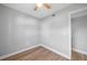 Neat bedroom featuring a ceiling fan and wood floors, offering a clean and simple space at 31 Oberlin Rd, Venice, FL 34293
