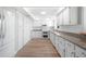 Bright kitchen with new stainless appliances, gorgeous white cabinetry, and hardwood floors at 31 Oberlin Rd, Venice, FL 34293