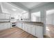 Eat-in kitchen featuring new stainless appliances, gorgeous white cabinetry, granite counters and hardwood floors at 31 Oberlin Rd, Venice, FL 34293