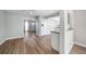 Bright living area featuring hardwood floors, open access to a kitchen, and great natural lighting at 31 Oberlin Rd, Venice, FL 34293
