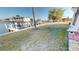 Spacious backyard with lush grass, waterfront canal access, and private boat dock at 311 Garvin St # 405A, Punta Gorda, FL 33950