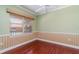 Empty bedroom featuring wood floors, a ceiling fan, a window and light-green painted walls at 3228 Purple Martin Dr # 116, Punta Gorda, FL 33950