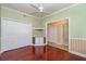 This is a spacious bedroom with hardwood floors, a ceiling fan and a closet at 3228 Purple Martin Dr # 116, Punta Gorda, FL 33950