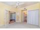 This bedroom has neutral colored carpet and access to other rooms and has white closet doors at 3228 Purple Martin Dr # 116, Punta Gorda, FL 33950