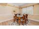 Inviting dining room with a glass-top table, seating for four, and stylish decor at 3228 Purple Martin Dr # 116, Punta Gorda, FL 33950