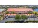 Condo building exterior with parking, landscaping, palm trees, and partial water view at 3228 Purple Martin Dr # 116, Punta Gorda, FL 33950