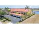 Exterior view of the building showcasing garages, parking, and mature landscaping at 3228 Purple Martin Dr # 116, Punta Gorda, FL 33950