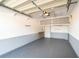 Clean, single-car garage with overhead storage cabinets and painted walls at 3228 Purple Martin Dr # 116, Punta Gorda, FL 33950