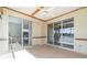 A screened patio with tile floors and sliding glass doors leading to the interior of the home at 3228 Purple Martin Dr # 116, Punta Gorda, FL 33950