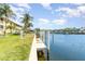 Waterfront view with a concrete dock and canal, with building exterior to the left at 3228 Purple Martin Dr # 116, Punta Gorda, FL 33950