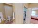 Bright half bathroom featuring a toilet, soft rug, and towel rack near a storage closet and bedroom at 327 Monaco Dr # 12, Punta Gorda, FL 33950