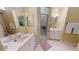 Well-lit bathroom with dual sinks, a glass-enclosed shower, and neutral finishes offers a clean and functional space at 327 Monaco Dr # 12, Punta Gorda, FL 33950