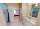 Bright bathroom featuring a vanity with open access to the main bedroom offers convenience and functionality at 327 Monaco Dr # 12, Punta Gorda, FL 33950