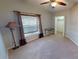 Minimalist bedroom with plush carpeting, a large window, and a convenient walk-in closet at 327 Monaco Dr # 12, Punta Gorda, FL 33950