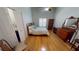 Cozy bedroom featuring a comfortable bed, stylish dresser, wood floors, and a ceiling fan at 327 Monaco Dr # 12, Punta Gorda, FL 33950