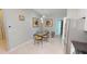Breakfast nook with a glass-top table, unique chairs, and modern pendant lighting at 327 Monaco Dr # 12, Punta Gorda, FL 33950