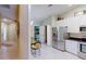 Dining area view, showcasing stainless steel refrigerator, ample storage, and tiled flooring at 327 Monaco Dr # 12, Punta Gorda, FL 33950