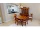 Charming dining area featuring a wooden table, china cabinet, and a view of the adjacent kitchen for easy serving at 327 Monaco Dr # 12, Punta Gorda, FL 33950