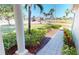 Home exterior featuring well-manicured landscaping, brick walkway, and view of the surrounding community at 327 Monaco Dr # 12, Punta Gorda, FL 33950