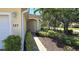 Inviting view of home's facade, showcasing the front yard with its lush landscaping and brick walkway at 327 Monaco Dr # 12, Punta Gorda, FL 33950