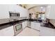 Kitchen boasting granite countertops, stainless steel appliances, and white cabinets at 327 Monaco Dr # 12, Punta Gorda, FL 33950