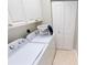 Efficient laundry room with white cabinets, a folding area on top of the units, and a bi-fold closet at 327 Monaco Dr # 12, Punta Gorda, FL 33950