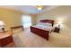 Serene main bedroom with carpet flooring and a comfortable bed offers a peaceful retreat for rest and relaxation at 327 Monaco Dr # 12, Punta Gorda, FL 33950