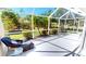 Enclosed patio with seating area overlooking the green lawn and tropical landscaping offers a private outdoor retreat at 327 Monaco Dr # 12, Punta Gorda, FL 33950