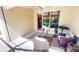 Covered patio with wicker furniture, perfect for lounging and entertaining, seamlessly extends the indoor living space at 327 Monaco Dr # 12, Punta Gorda, FL 33950