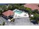 A pool and hot tub in a community with lounge chairs, landscaping, and a nearby parking area at 327 Monaco Dr # 12, Punta Gorda, FL 33950
