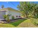 Charming home exterior with a two-car garage, freshly landscaped flowerbeds, and manicured lawn at 3291 Horace Ave, North Port, FL 34286