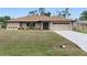 Well-maintained ranch-style home with manicured landscaping and a two-car garage at 3487 Brooklyn Ave, Port Charlotte, FL 33952