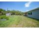 Large backyard featuring a storage shed, garden beds, and plenty of open space at 4229 Cockrell St, Port Charlotte, FL 33948