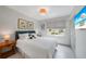 This bedroom offers natural light, white bedding and neutral colors at 4229 Cockrell St, Port Charlotte, FL 33948