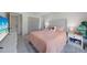 This bedroom features a gray tufted headboard, coral bedding, and ensuite bathroom at 4229 Cockrell St, Port Charlotte, FL 33948