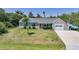 Attractive single-Gathering home with a lush lawn, palm tree, and spacious driveway leading to a garage at 4229 Cockrell St, Port Charlotte, FL 33948