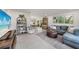Spacious living room featuring stylish furnishings, tile floors, and seamless transition to dining area at 4229 Cockrell St, Port Charlotte, FL 33948