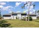 Backyard view of condo with enclosed patios and landscaping at 4260 Placida Rd # 13B, Englewood, FL 34224