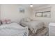 Cozy bedroom offers two beds, a window and neutral decor at 4260 Placida Rd # 13B, Englewood, FL 34224