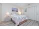 Bright bedroom features neutral paint, beach themed art and gray flooring at 4260 Placida Rd # 13B, Englewood, FL 34224