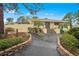 Inviting clubhouse entrance with a well-manicured garden, stone pathways, and mature landscaping at 4260 Placida Rd # 13B, Englewood, FL 34224